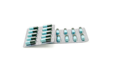 Close up on tablets and capsules pill in blister packaging, Pharmaceutical industry concept. Pharmacy drugstore, Amoxicillin capsule pills isolated on white background.
