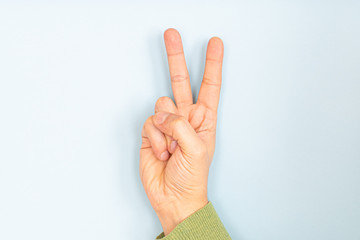 victory gesture by man hand isolated on white background