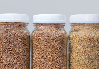 Close up of mason jars filled with grains.  Food storage glass containers are filled with: whole...