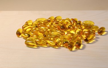 Yellow capsules with oil for media and ingestion