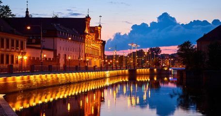 Fototapeta na wymiar The promenade of Wroclaw - European Capital of Culture, view from river Odra, after sunset at night. Poland, Europe.