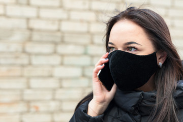 Lady with a black respirator mask.