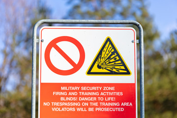 A warning sign on the edge of a military training area in Germany. Entering the site is dangerous....