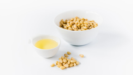cedar oil with nuts on a white background