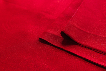 Beautiful fabric of one color is folded on a table in daylight