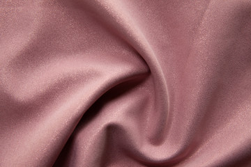 Beautiful fabric of one color is folded on a table in daylight