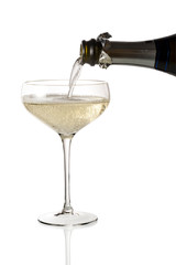 Bottle pouring sparkling wine into champagne cup glass © antoniotruzzi