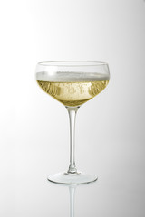 Glass cup with sparkling wine with foam