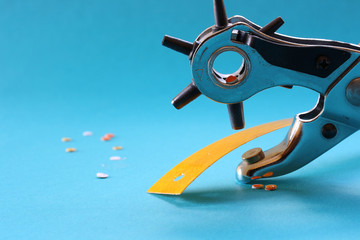 Puncher and yellow ribbon on a turquoise background