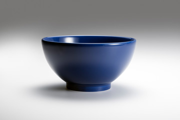 Empty blue bowl on white background