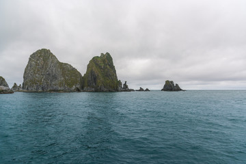 Naklejka premium Scenic high rocks in the Pacific Ocean. Kamchatka Peninsula.