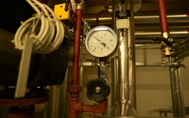 round analog display with pointer in a technical room