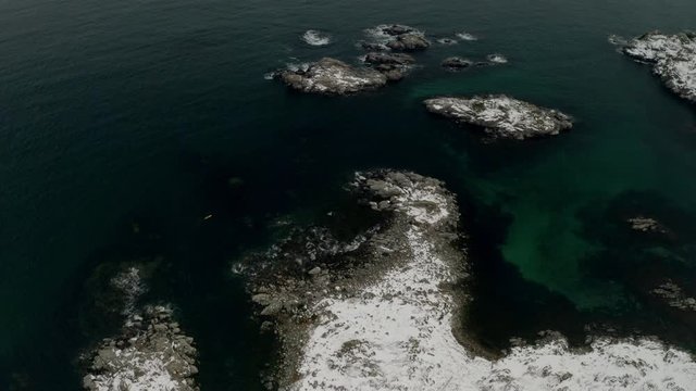 aerial motion timelapse of typical lofoten islands view druing winter in ballstad town. snowy mountains in background