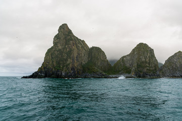 Fototapeta na wymiar Scenic high rocks in the Pacific Ocean. Kamchatka Peninsula.