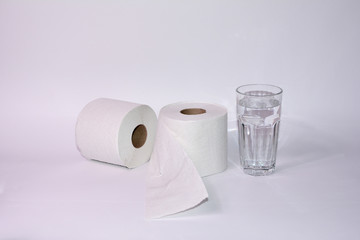 Toilet paper rolls with a glass of water