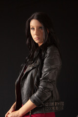 Dark-haired girl in a leather jacket - low key