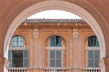Fototapeta na wymiar peach fuzz colour architecture exterior background, arch with three windows in the background