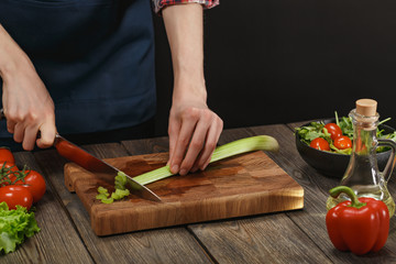 Woman cooking fresh vegetable salad. Female hands. Diet concept for healthy lifestyle with copyspace.