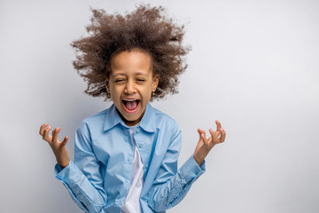 portrait of little excited or african girl isolated over white background. child with curly hair,...