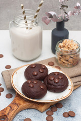 Chocolate chip cookies with glass of milk on gray background