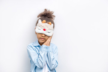 portrait of child, tired little girl, child want to sleep. girl in mask for sleeping. isolated white background