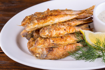 Fried drum, served with sauce and greens