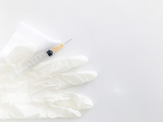 syringe and gauze with sterile dispose glove on white background with copy space in medical...