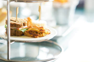 mini smoked salmon berger and pie on plate and stand with copy space