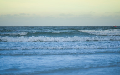 Naklejka na ściany i meble blur sea waves on sky background in selective focus