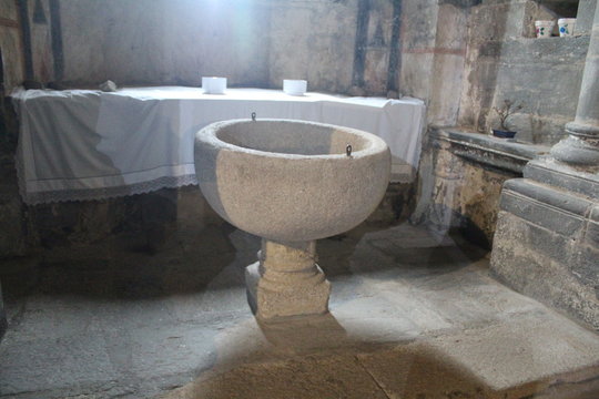 Beautiful old stone baptismal font where it is converted to Christianity