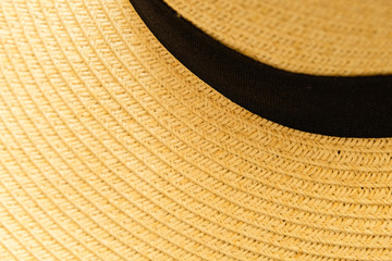 Fototapeta na wymiar Close up shot to see the detail of straw hat weave texture detail. Craft and handmade product during summer season. Ideal for wallpaper, background with copy space for text,