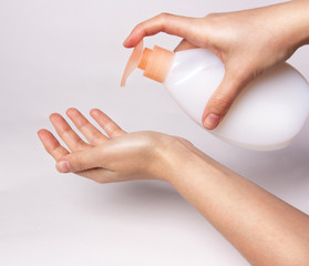Female hands using wash hand sanitizer gel pump dispenser. virus protection