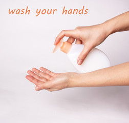 Female hands using wash hand sanitizer gel pump dispenser. virus protection