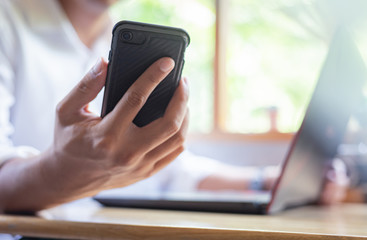 Asian businessman using the smartphone in a coffee shop