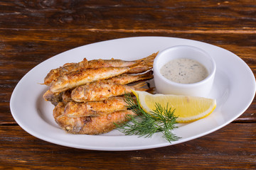 Fish drum fried in crumbs, with sauce and greens