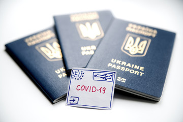 Drawn stamp with the words "coronavirus" on the background of foreign passports.
