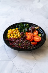 Healthy Black Rice Salad with Turmeric Chickpea, Kale, Cherry Tomatoes / Forbidden rice or Oryza Sativa.