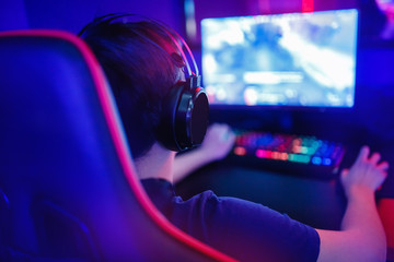 Cyber video gamer studio with computer for stream in neon blue red color blur background. Soft focus © Parilov