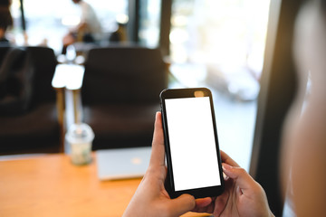 Close up of man using cell phone,sending massages on the coffee shop with black screen,texting,video calls.