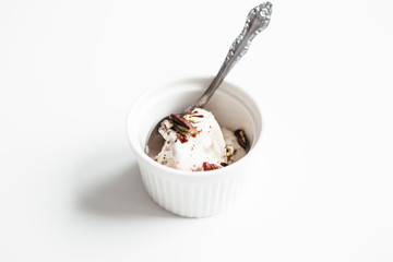 Healthy coconut ice cream with pecans on white background close up. Fresh and tasty