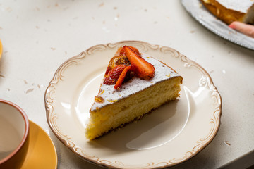 Homemade Victoria Sponge Cake Slice with Strawberry, Dried  Lemon Slices and Powdered Sugar.