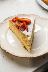 Homemade Victoria Sponge Cake Slice with Strawberry, Dried  Lemon Slices and Powdered Sugar.