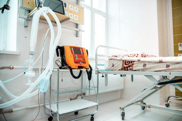 Plastic tubes for artificial lung ventilation apparatus and defibrillator for rescue of coronavirus patients in a modern hospital in the intensive care ward.