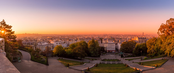 A colorful, panoramic cityscape at sunrise taken from Montmartre Hill, Paris, France