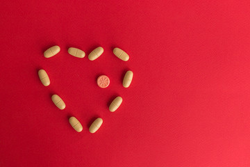 Healthy concept with Pharmaceutical medicine pills, tablets and capsules on red background. Medicine hert love creative concepts. medical pattern, top view, flat lay. Copy space