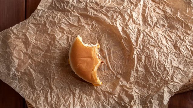 stop motion animation, eating, burger is eaten piece by piece, top view