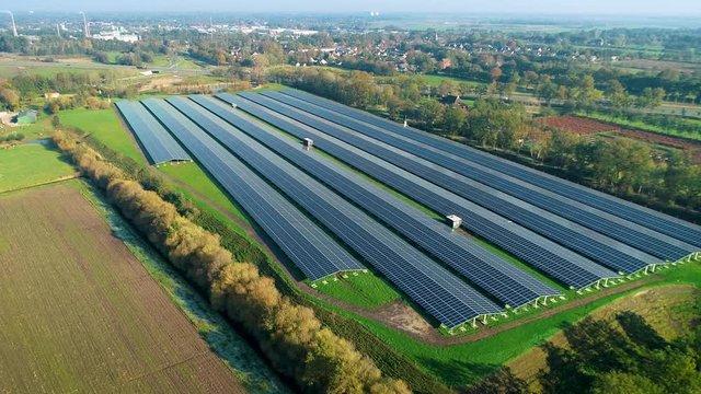 Solar Plant Overview: Rows of Solar Panels Producing Sustainable Energy, Zooming Out - Friesland, Netherlands / Holland &ndash; 4K Drone Footage