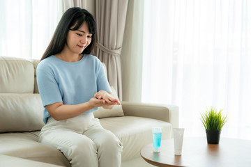 Asian womanl using alcohol antiseptic gel, prevention, cleaning hands frequently, prevent infection, outbreak of Covid-19 wash hands with hand sanitizer to avoid contaminating..