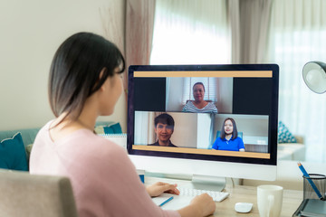 Asian business woman talking to her colleagues about plan in video conference. Multiethnic business...