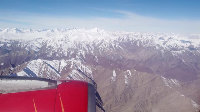 Aerial view of the Himalayas mountain range looking through airplane window
